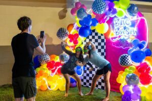 Charleston Southern Buc Bash balloon arch with two students posing.