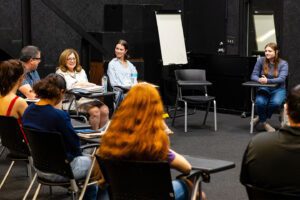 Group of Charleston Southern University communication students gathered with professor in studio.