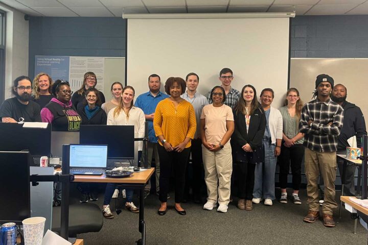 Alumni speakers pose with attendees of the Network + Bootcamp event at CSU. N’dia Thomas is in the middle of the first row, and Derick Beckwith is on the far left of the first row.